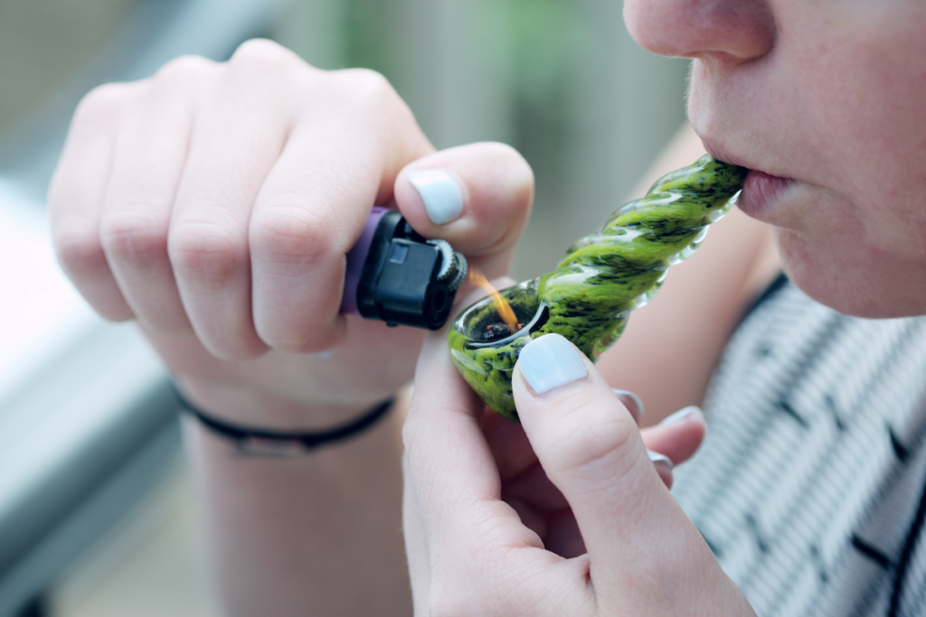Lighting weed in a pipe to smoke