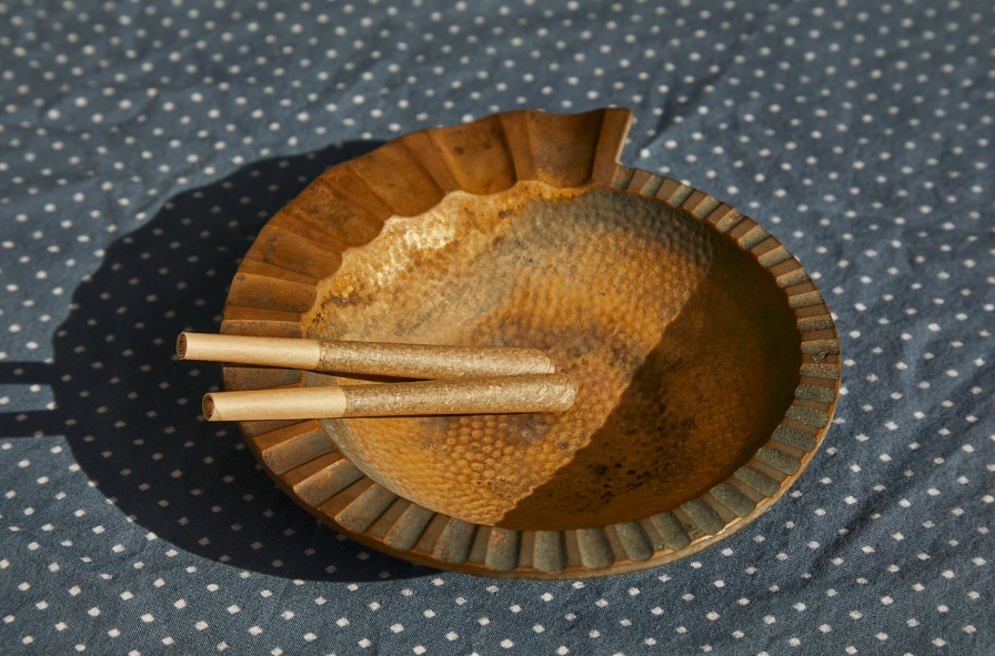 Two unsmoked pre-roll joints resting in an ashtray