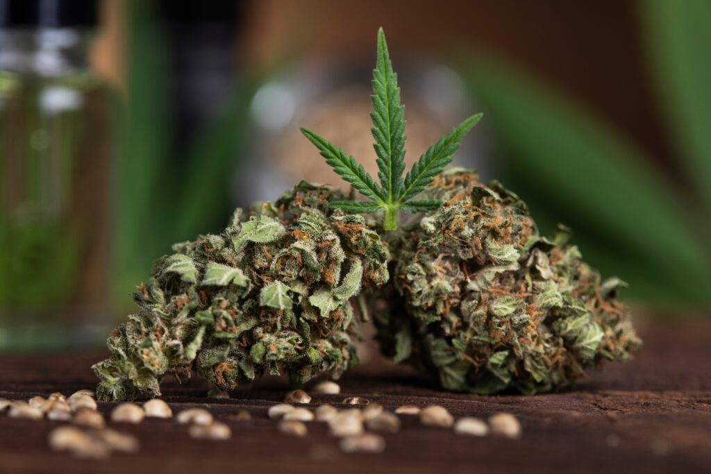 Weed flowers and leaf sitting in the foreground of table